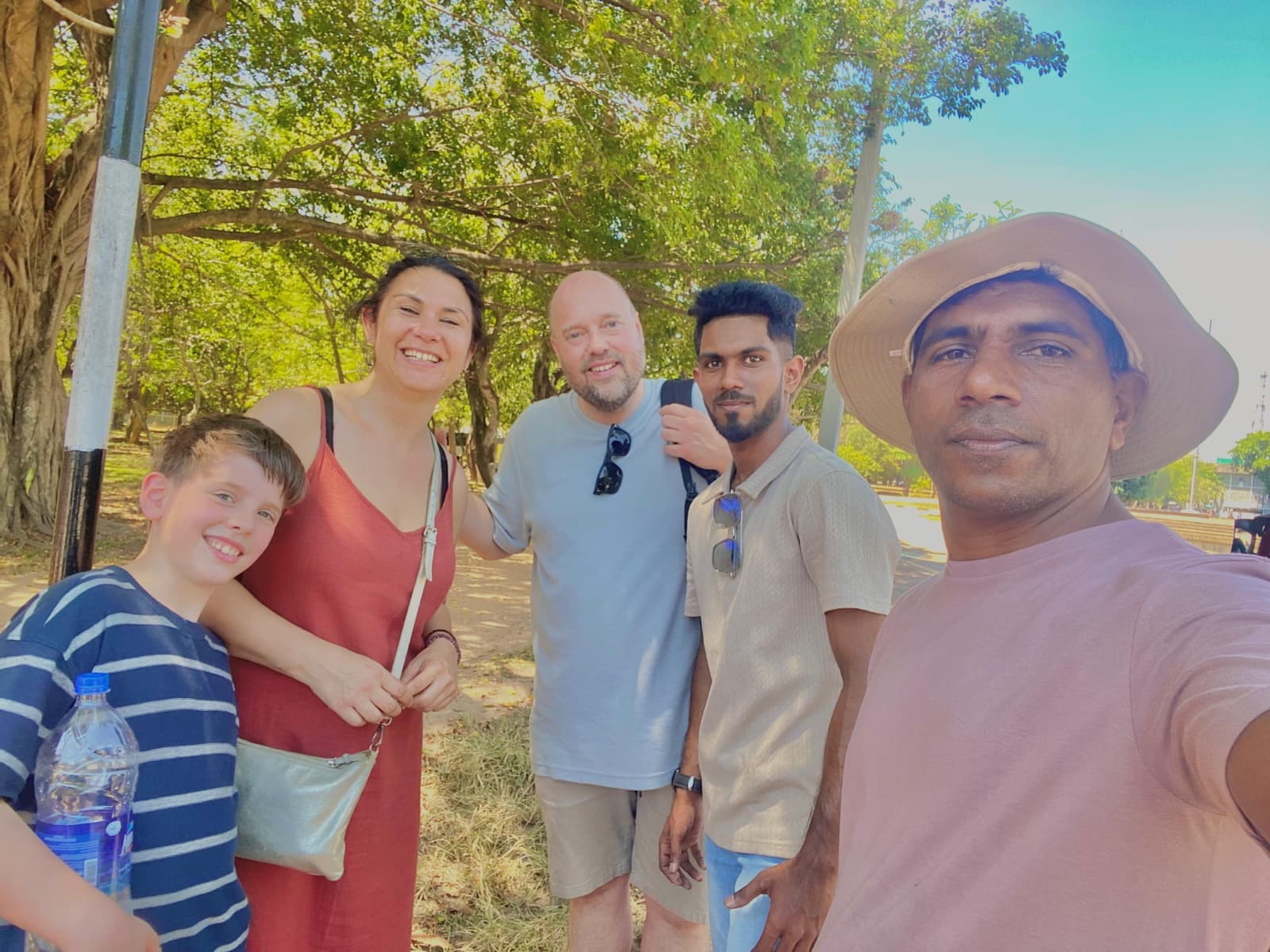 David's selfie with a family in a leafy Colombo park