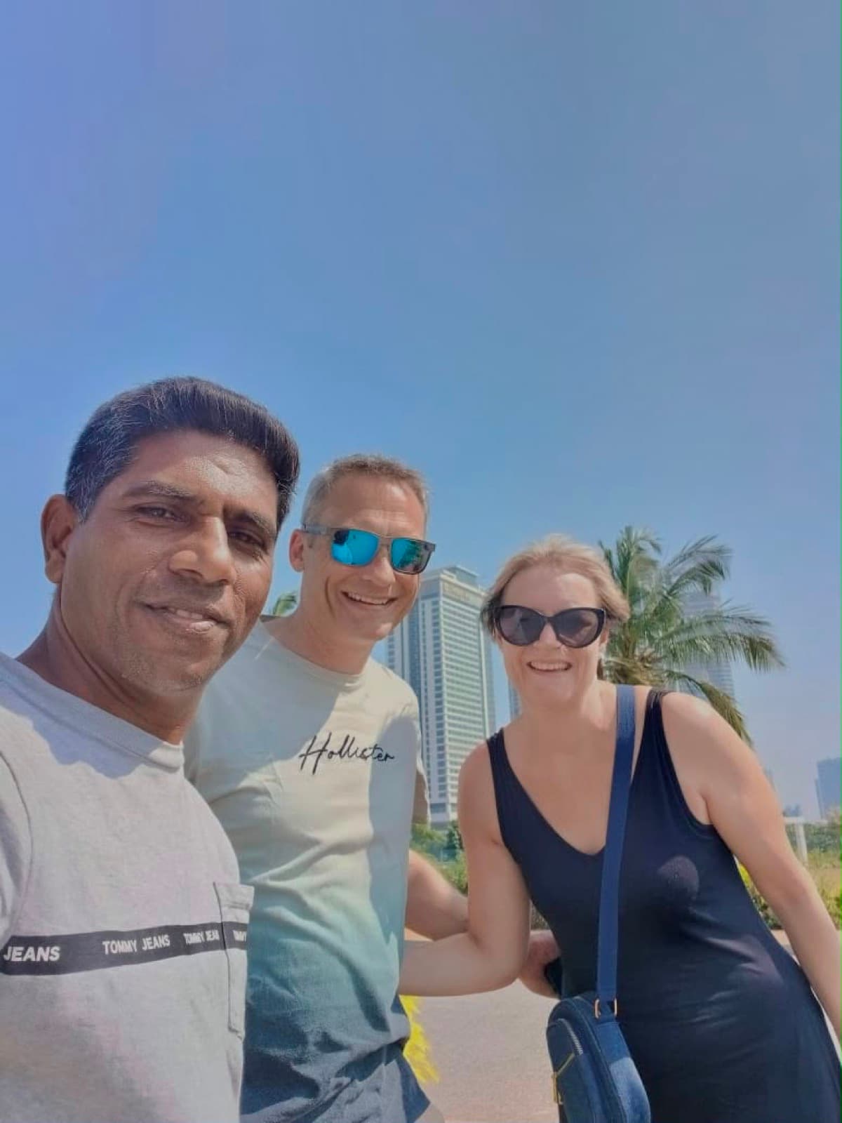 David and a couple along Galle Face with the Colombo skyline